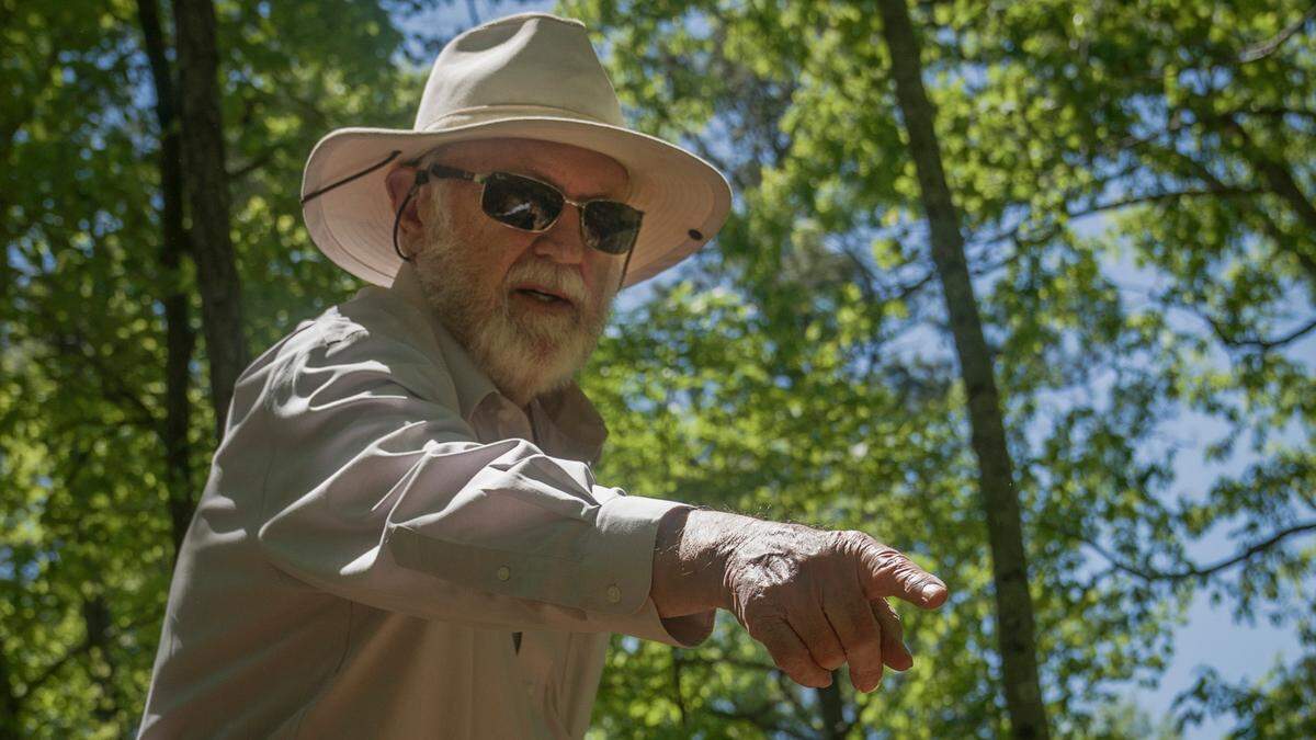 Ralph Howard gestures towards an endangered plant colony at Whispering Hills Memorial Nature Preserve on April 19, 2021 in LaGrange, Ga.