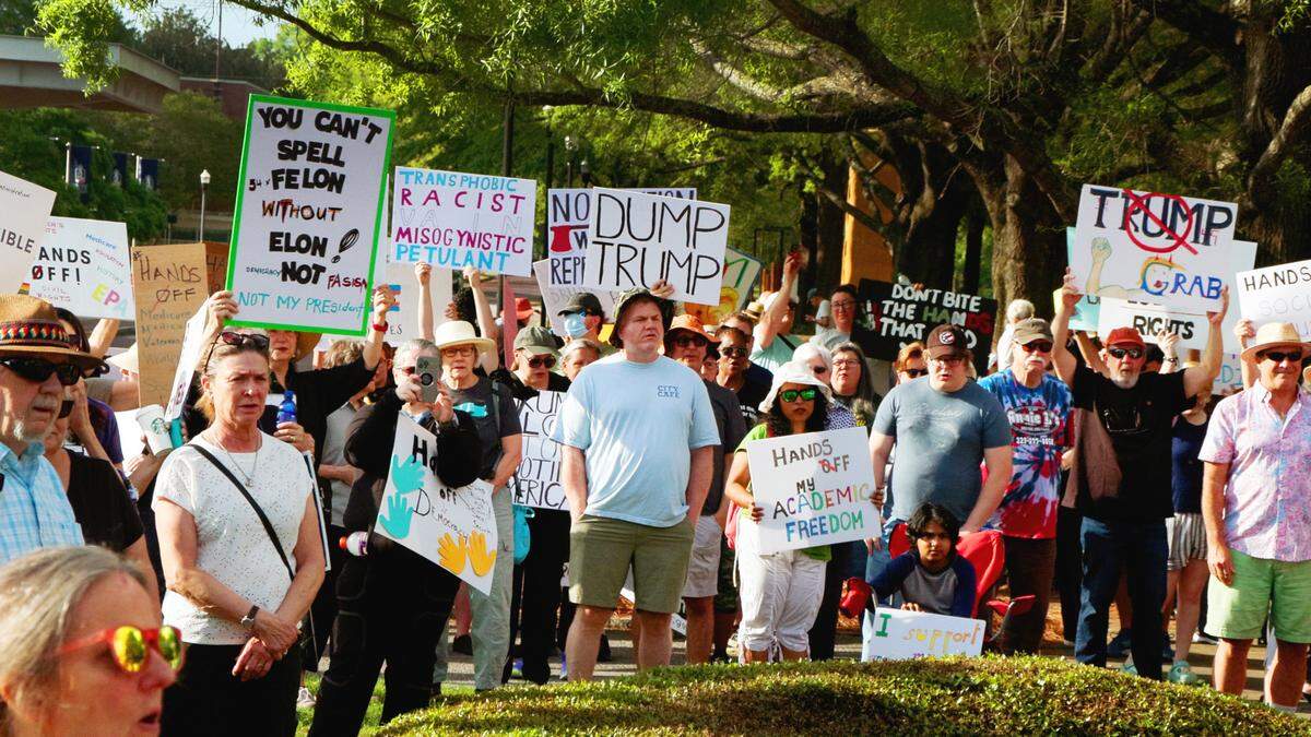 Participants in the “Hands Off” rally hosted by Indivisible Columbus gather at the corner of Broadway and 10th Street Saturday morning in downtown Columbus, Georgia. 04/05/2025