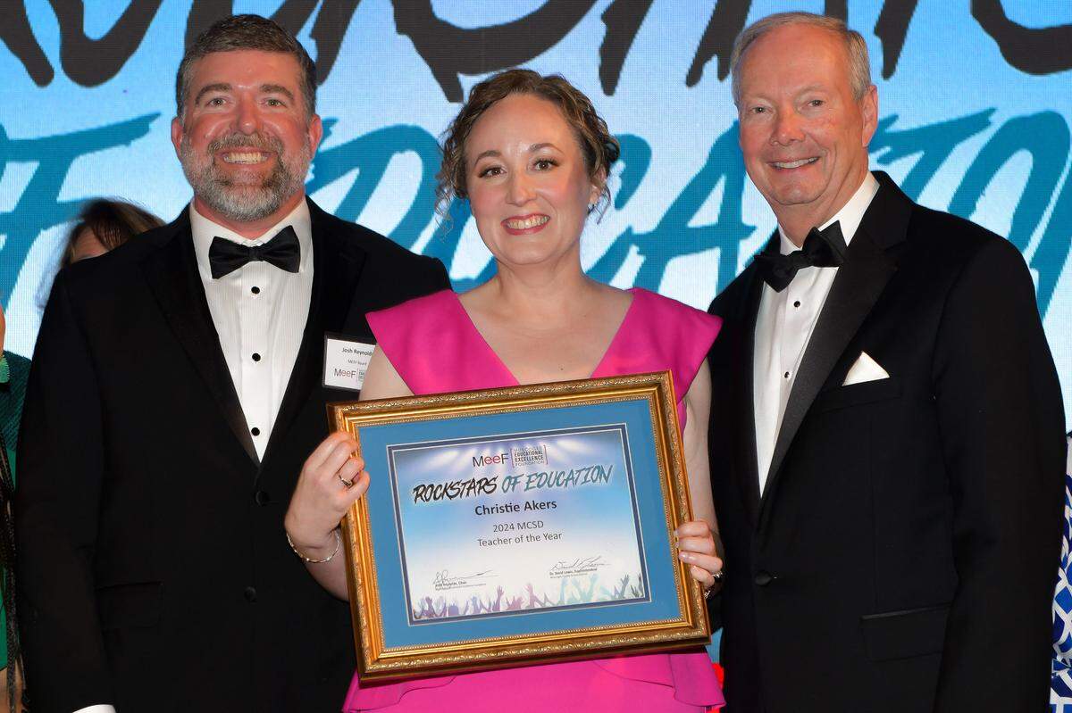 Muscogee County School District 2024 Teacher of the Year Christie Akers of Northside High School poses with her certificate along with Muscogee Educational Excellence Foundation chairman Josh Reynolds, left, and MCSD superintendent David Lewis during MEEF’s Teacher of the Year gala May 9, 2024, in the Columbus Convention & Trade Center.