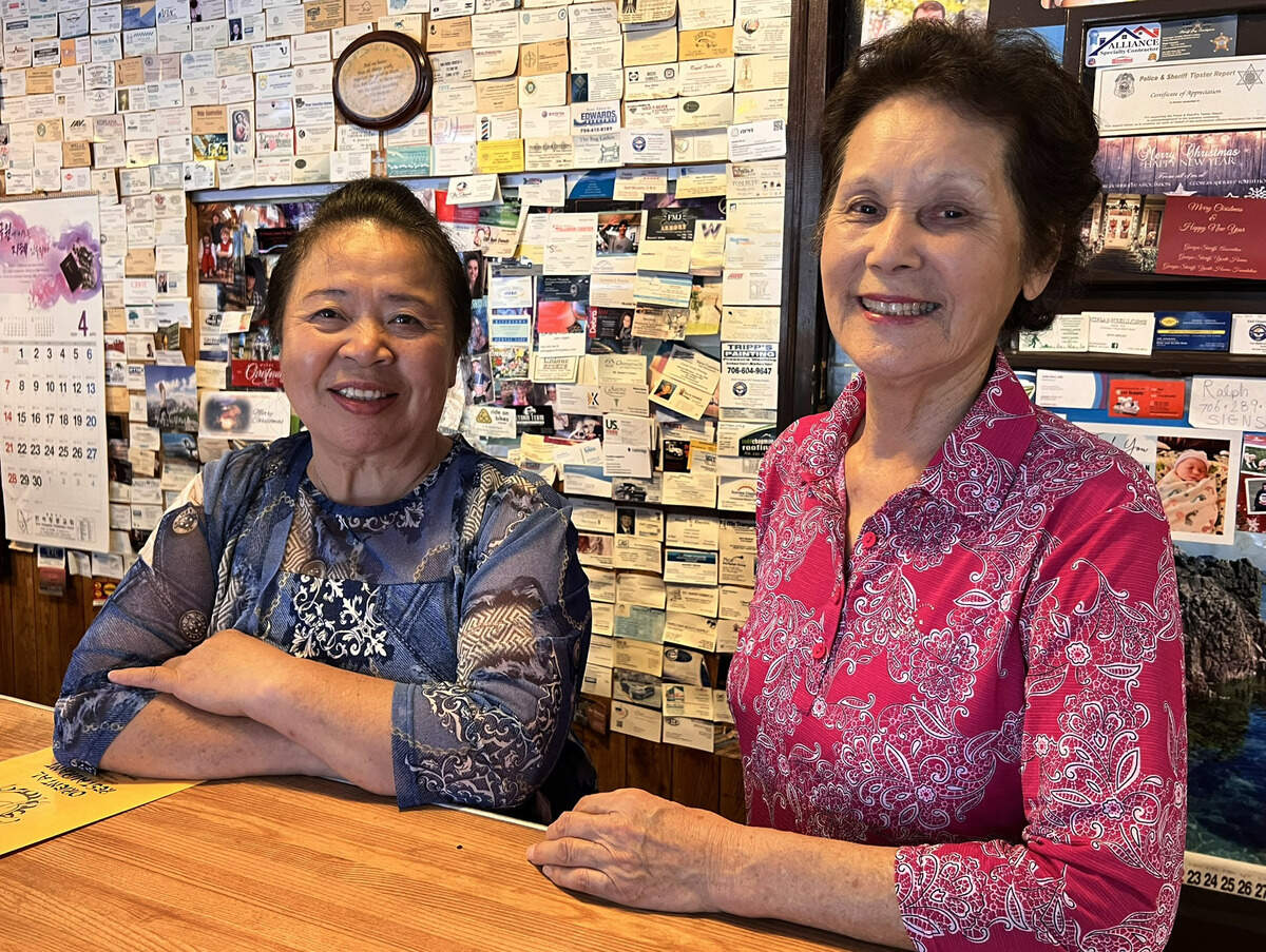 Bun Im Chong, left, and Ok Sun Ferrell pose for a photo oinside Ok Sun Oriental Restaurant in Columbus, Georgia. Ok Sun Oriental Restaurant will open to serve loyal customers in Columbus for one final week as it prepares to permanently this year.
