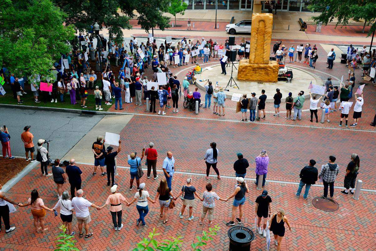 Hundreds of people gathered Saturday morning in the 900 block of Broadway in downtown Columbus, Georgia, for a “No Kings” themed demonstration.