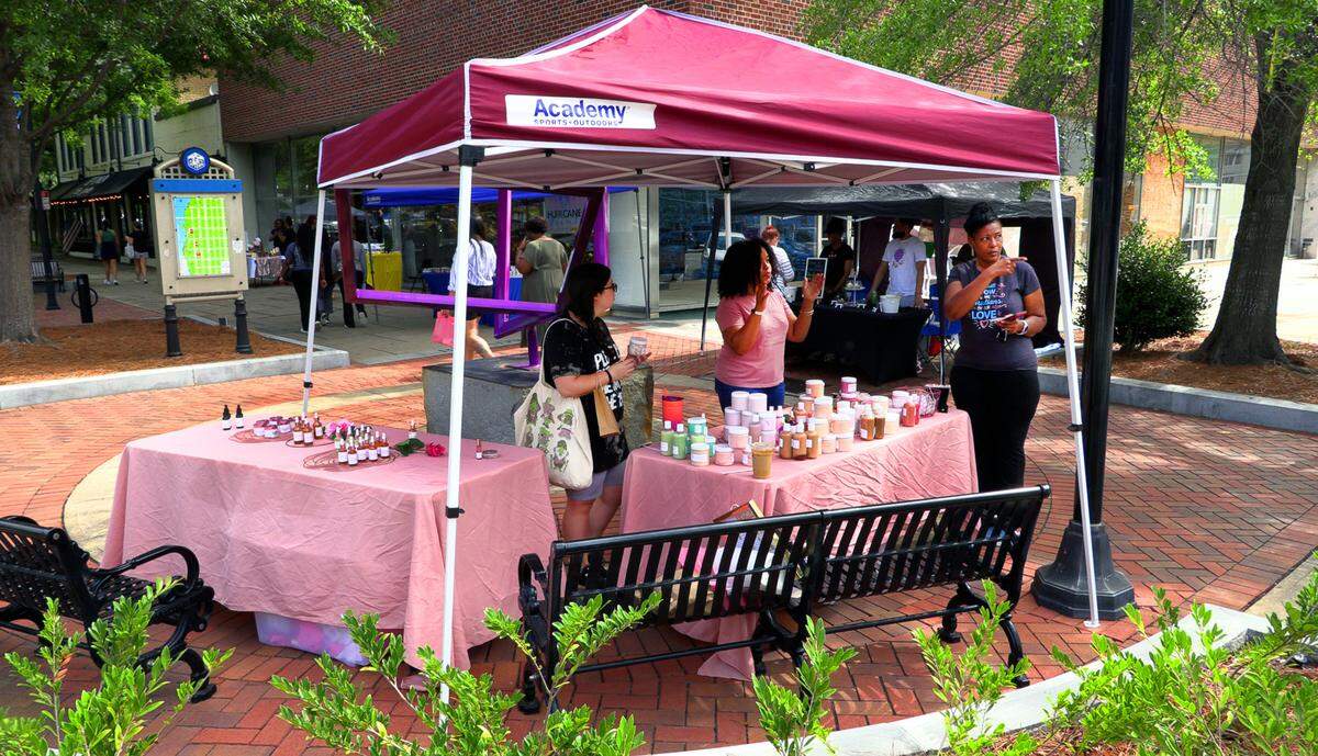 Kristi Pitts, center, the owner of The Crowned Beauty Co., is preparing to open a brick-and-mortar Crowned Beauty Co. store in downtown Columbus in the Rankin Building on 10th street later this month. She will continue to offer her products during Market Days on Broadway. 05/04/2024