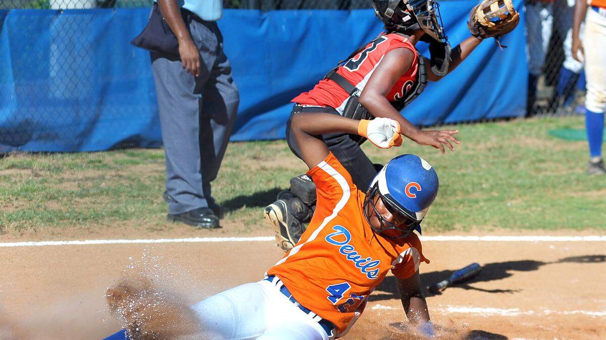 Columbus' Marlisa Scott slides into home beating the throw to Shaw's Jordan Bagsby in the 1st inning of the game Tuesday evening