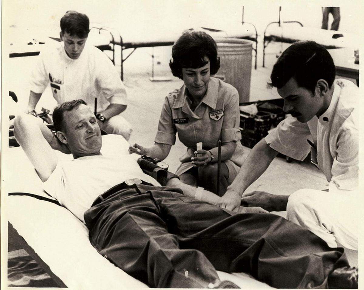 Even as a General’s wife, Julie Moore volunteered for the Red Cross, shown here drawing blood from Maj. Gen. Hal Moore in Korea when the family was stationed there from 1969 to 1971.