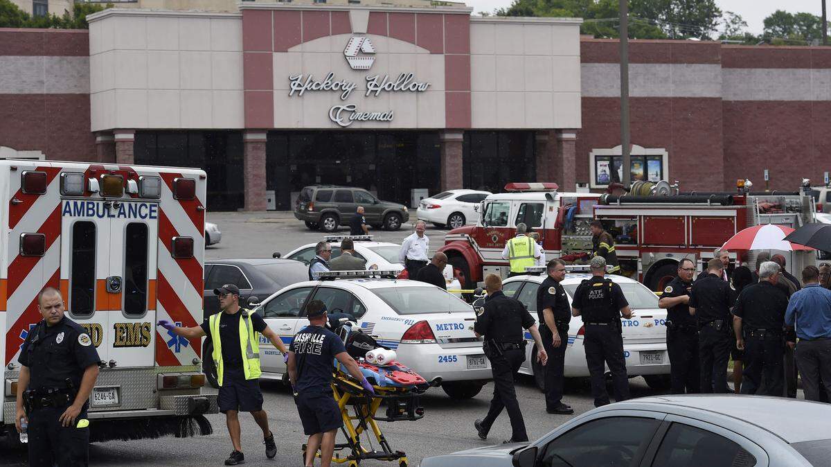 Emergency personnel gather outside Carmike Hickory 8 movie theater following a shooting Wednesday, Aug. 5, 2015, in Antioch, Tenn. A suspect wielding a hatchet and a gun inside the Nashville-area movie theater died after exchanging gunshots with a SWAT team that stormed the theater, police said. (AP Photo/Mark Zaleski)