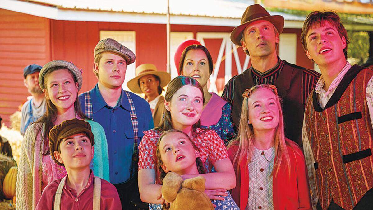 In this promotional image from The CW Network movie “A Waltons Thanksgiving,” Columbus High School and University of Georgia graduate Vivian Lee-Boulton as Edith (back row, far left) watches fireworks along with (back row, from left) Logan Shroyer as John Boy Walton, Bellamy Young as Olivia Walton, Teddy Sears as John Walton, Christian Finlayson as Jason Walton, (front row, from left) Samuel Goergon as Jim Bob Walton, Marcelle LeBlanc as Mary Ellen Walton, Tatum Sue Matthews as Erin Walton, and Callaway Corrick as Elizabeth Walton.