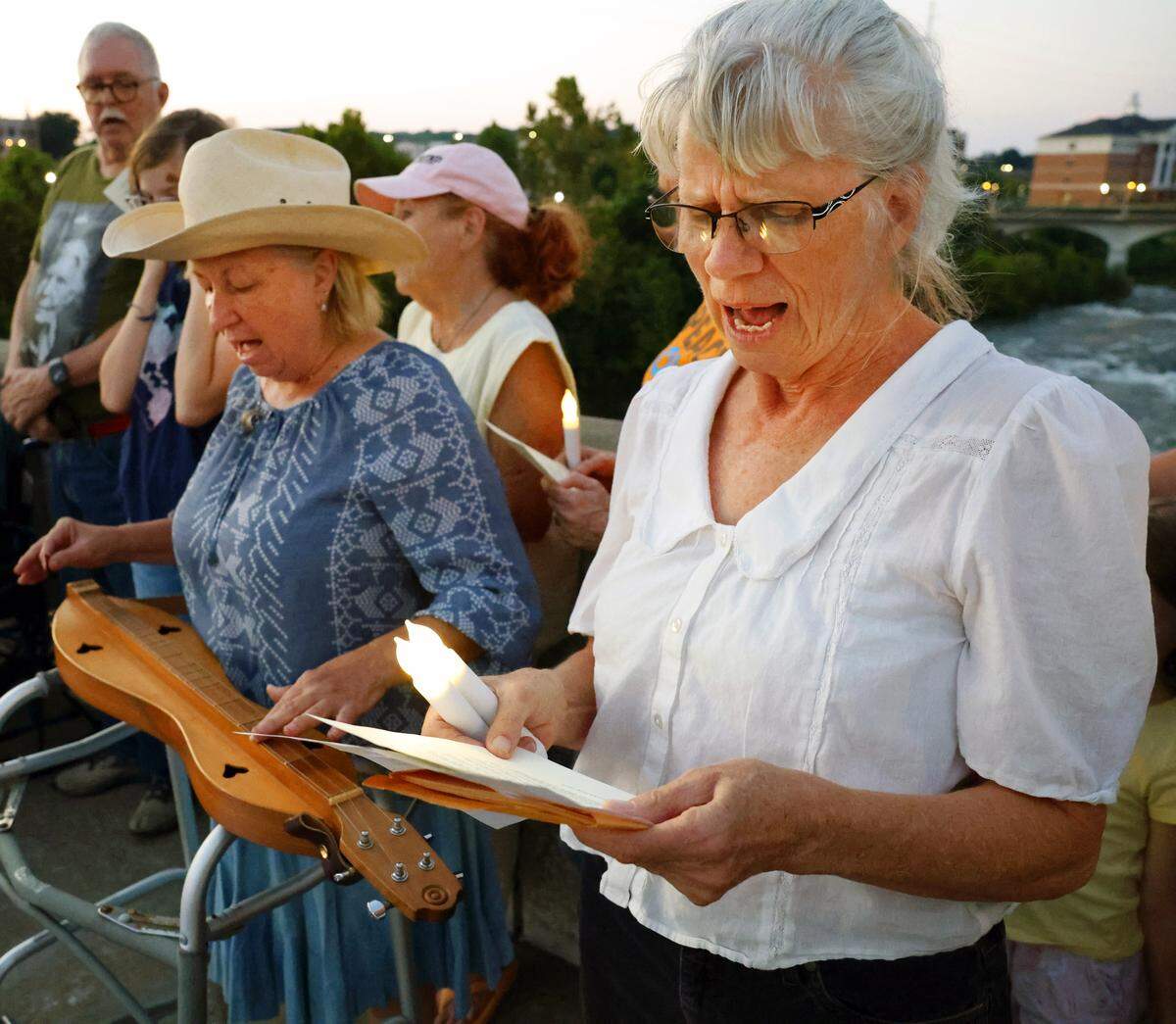 People gather Sept. 4, 2025, on the 13th Street Bridge, which connects Columbus, Georgia, to Phenix City, Alabama, for a candlelight vigil to remember and honor victims of gun violence. The event was organized by Phenix City Indivisible, Columbus, GA Indivisible and the Under the Muscadine Catholic Worker community.