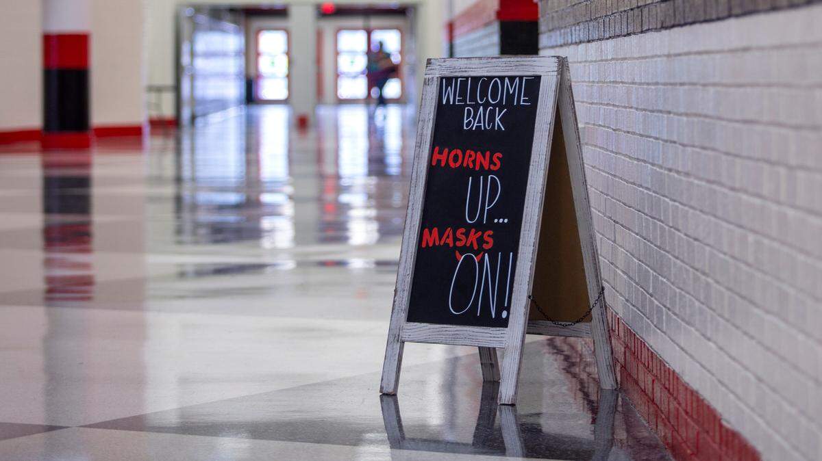A sign reminds students to mask up on their first day of school at Central High School on Tuesday, August 18, 2020 in Phenix City, Ala.