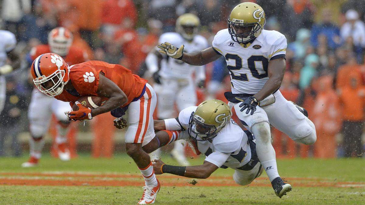RICHARD SHIRO/Associated PressClemson's Germone Hopper, left, slips the tackle attempt of Georgia Tech's Corey Griffin, center, and Lawrence Austin during the first half Oct. 10 in Clemson, S.C.