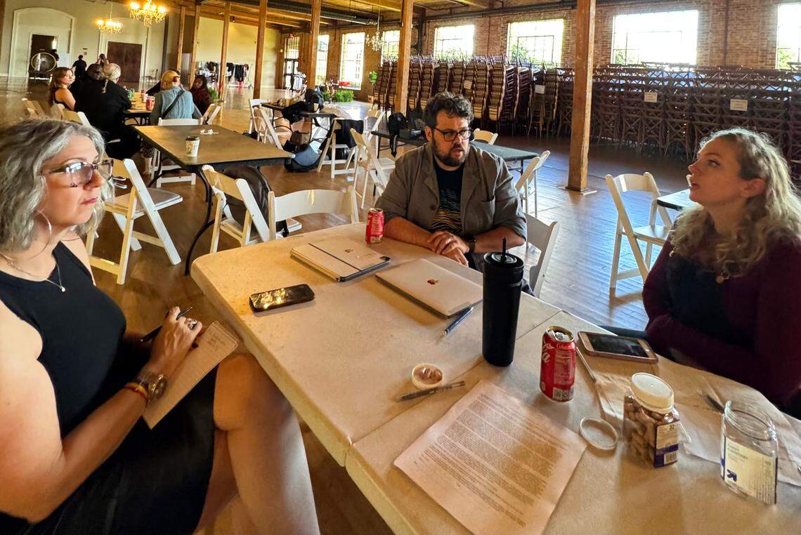 Ledger_Enquirer reporter Sundi Rose, left, talks with the owners of Columbus Casting, Jef and Sarah Holbrook, Monday afternoon at the Bibb Mill Event Center in Columbus, Georgia.