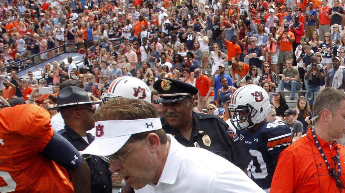 ROBIN TRIMARCHI rtrimarchi@ledger-enquirer.com
Auburn head coach Gus Malzahn lead the Tigers onto the field for the A-Day game Saturday at Jordan-Hare Stadium.  04.18.15