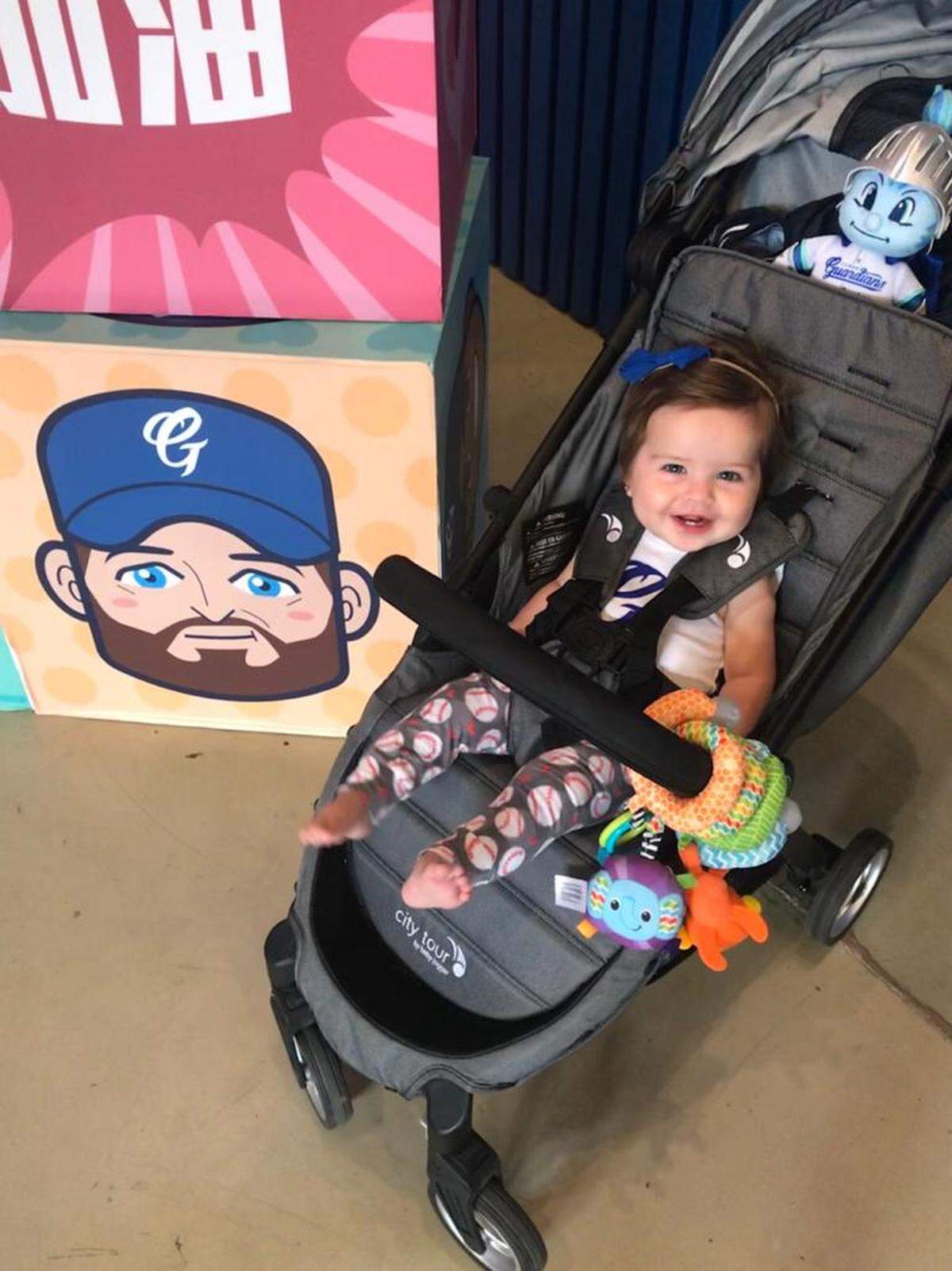 Nineteen-month-old Emory Woodall pictured with a cartoon face of her father, Bryan Woodall, in New Taipei City, Taiwan.