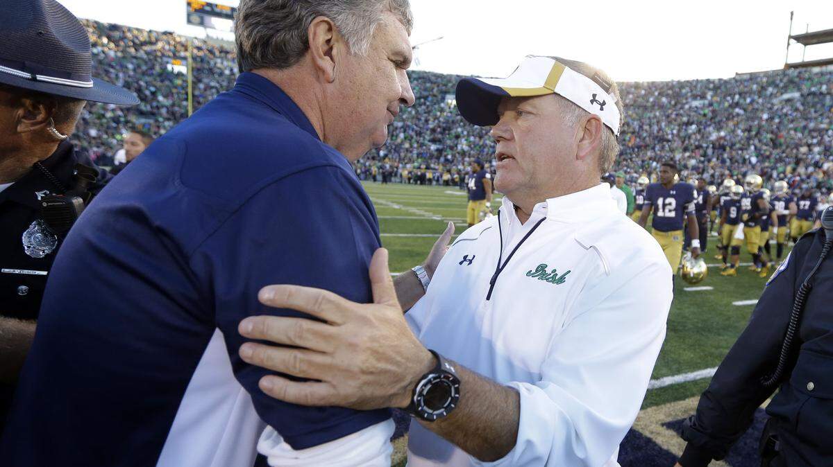 MICHAEL CONROY/Associated PressNotre Dame coach Brian Kelly, right, is greeted Saturday by Georgia Tech coach Paul Johnson in South Bend, Ind. Notre Dame defeated Georgia Tech 30-22.