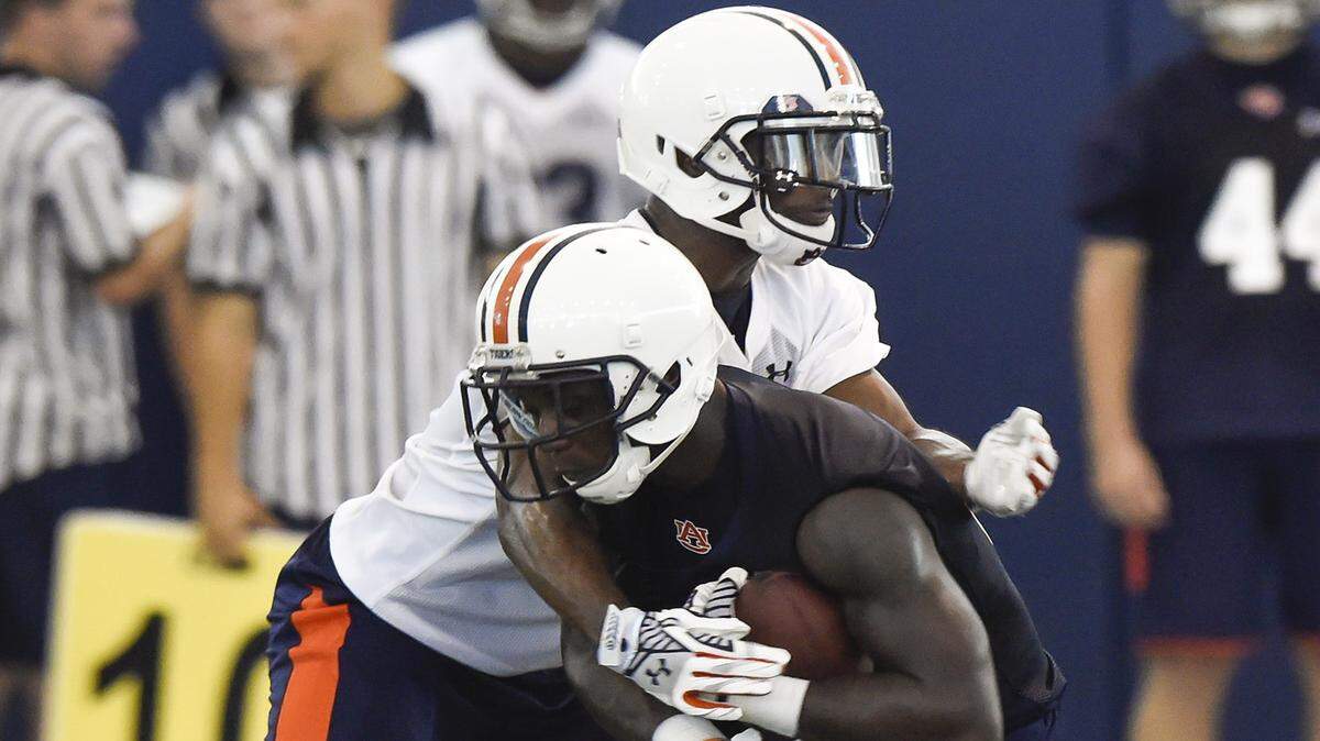 Blake Countess (24) wraps up Melvin Ray (82) during Auburn's practice on Wednesday. 