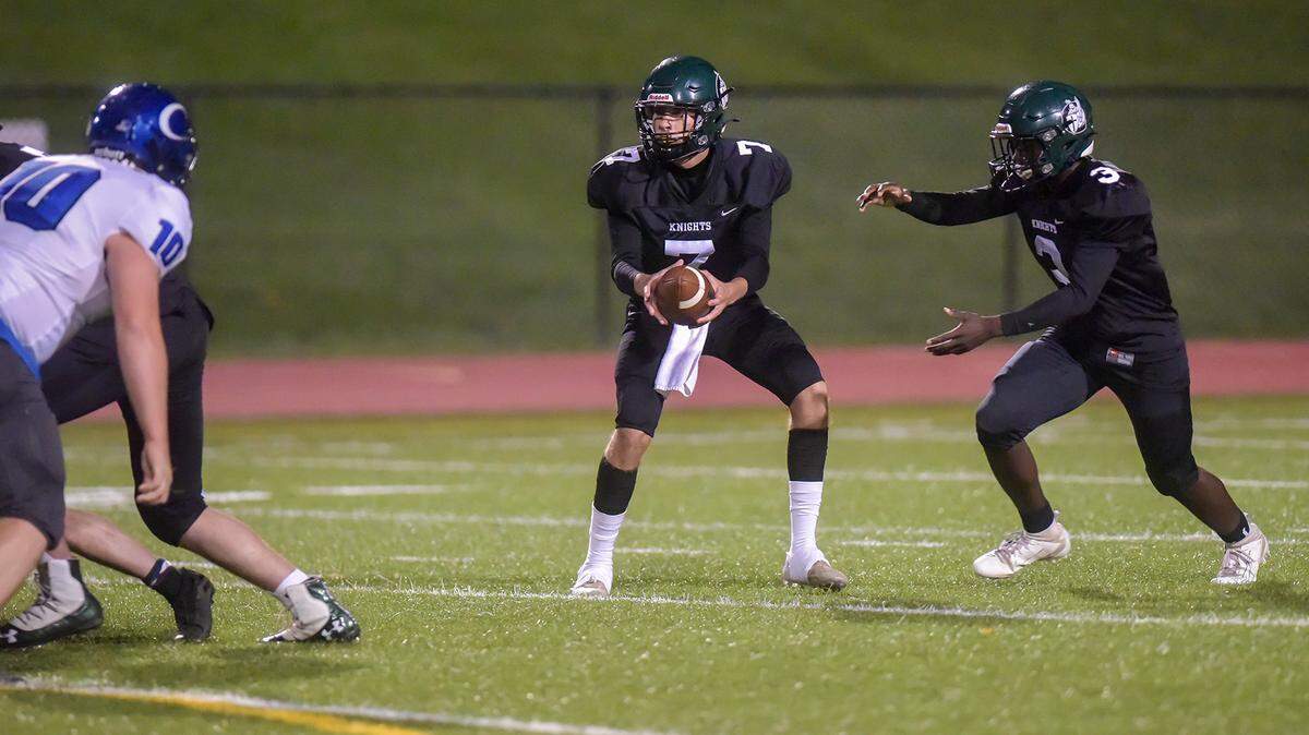 Calvary’s Jesse Donohoe hands off to Elijah Chestnut in the 2nd quarter of the game against Community, Friday night at Kennett Stadium, October 30, 2020 