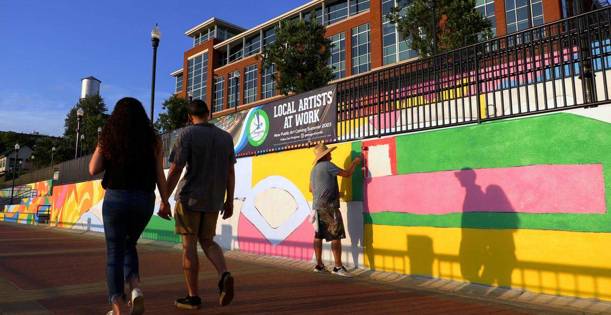 Chris Johnson, a muralist and retired Andrew College professor of art, is leading the design team in painting a mural along the Chattahoochee Riverwalk.The mural stretches along the riverbank’s three-tiered retaining wall where the Synovus Centre, 1111 Bay Ave., overlooks the Riverwalk between two of the most popular attractions on the riverfront: Waveshaper Island and Woodruff Park. 06/15/2023