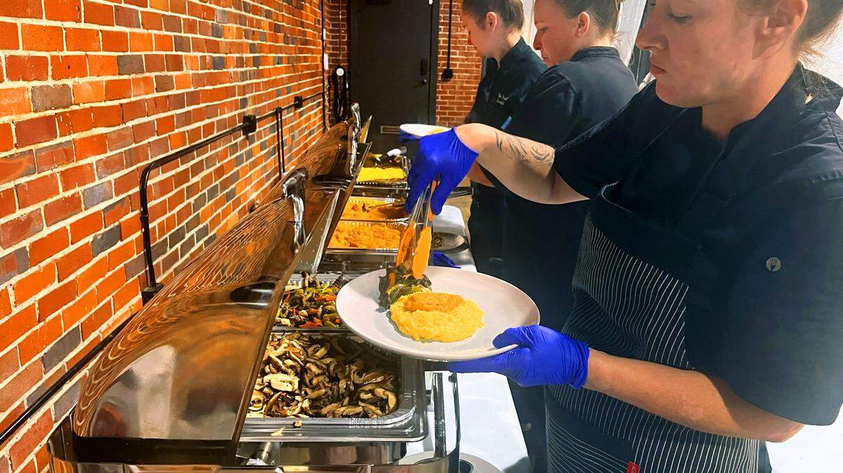 Food Mill Chef and City Farm Feast Chef Lauren Havican serves the main course: butternut squash, polenta, mushrooms, and bell peppers.