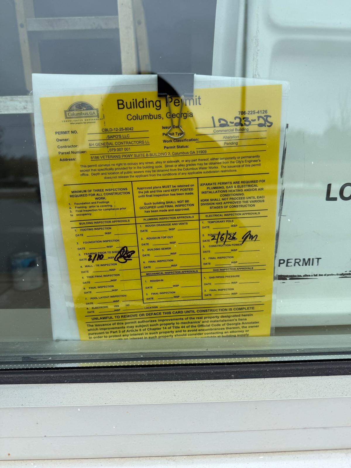 A building permit is posted to the window of the former Pure Taqueria space at 8186 Veterans Parkway in Columbus.