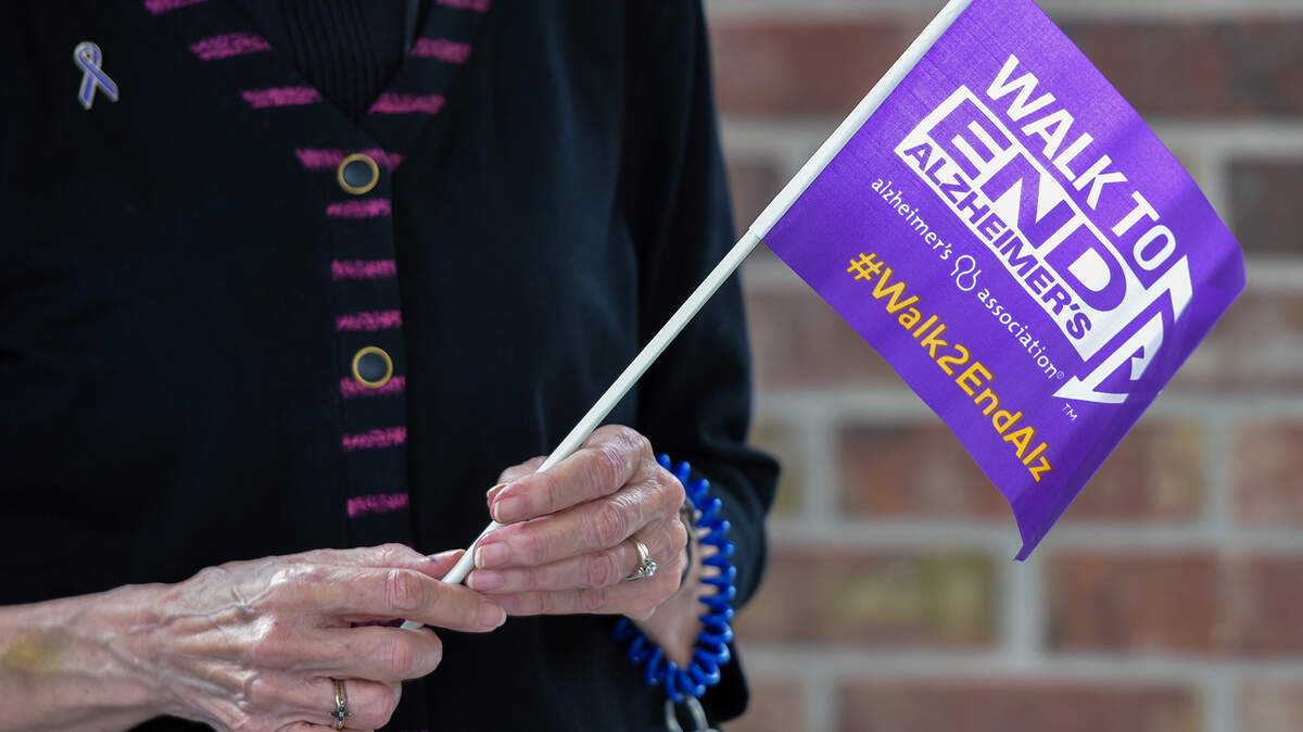 Covenant Woods Retirement Community resident Mabel Ditchfield carries a Walk to End Alzheimer’s flag Friday morning during their Walk in the Woods event. Covenant Woods hosted Friday morning a “Walk in the Woods” as part of this year’s Alzheimer’s Association Walk to End Alzheimer’s. The ongoing coronavirus pandemic forced the cancellation of large in-person gatherings and fundraising walks, so groups and organizations such as Covenant Woods were encouraged to walk in small teams of friends and family. The Covenant Woods Walkers Team has a goal of raising $2,000 for the Alzheimer’s Association this year. Their deadline is December.