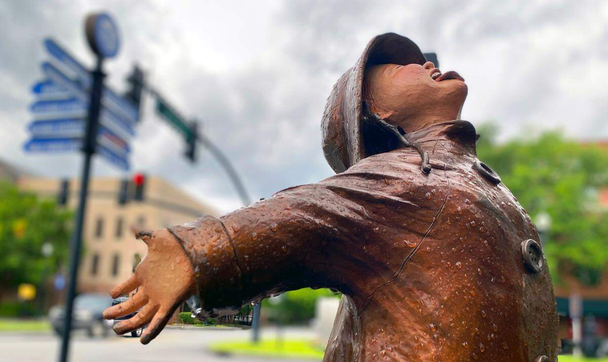 “May Flower” by Susan Geissler, a sculpture at the corner of 10th Street and Broadway in downtown Columbus, Georgia, is covered in rain drops after a passing round of storms Wednesday morning. 06/14/2023