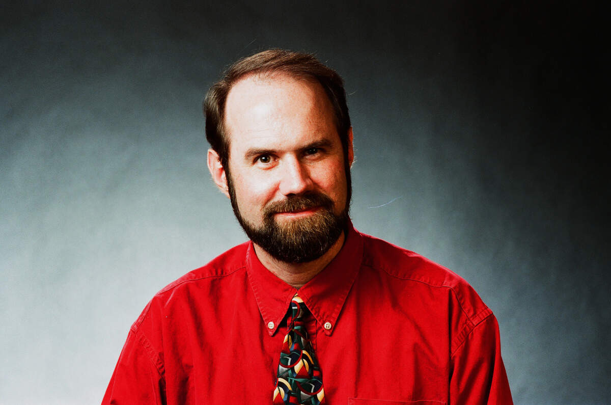 Ledger-Enquirer reporter Tim Chitwood sits for a new photograph to accompany his column.