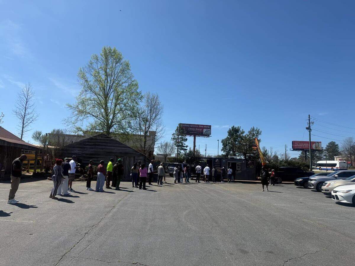 People wait in line at a Big Slim Meal Prep & Catering pop-up food truck in Columbus.