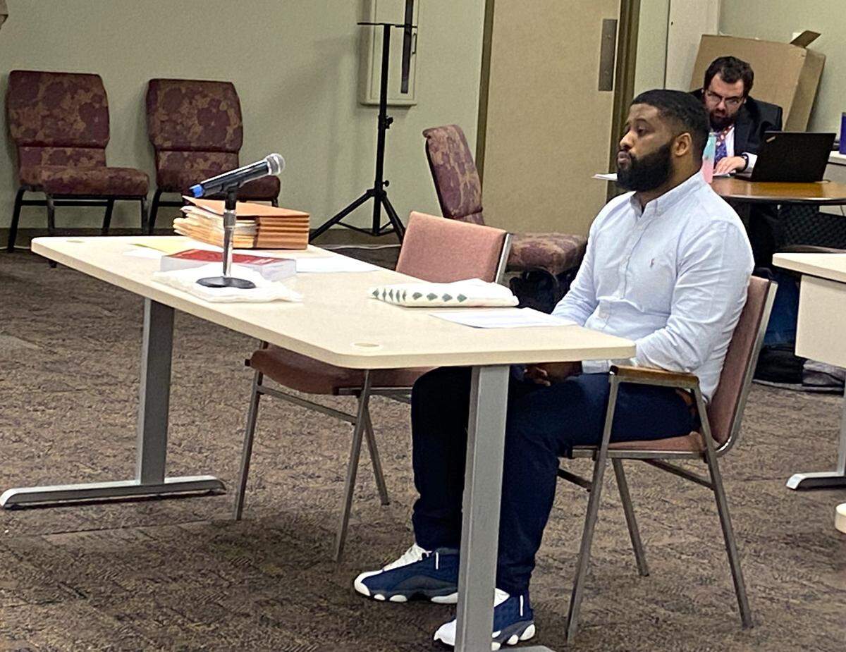 Murder suspect Ruben Hensley sits alone during a break in the court proceedings.