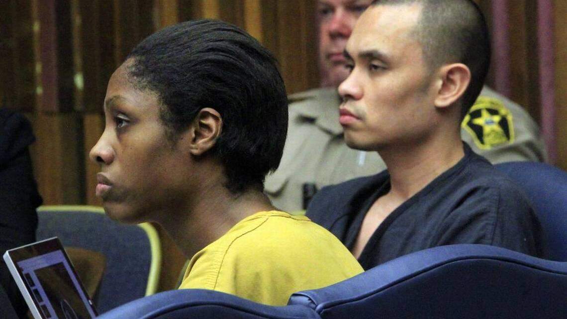 Ashley Debelbot, left, and Albert Debelbot, right, listen to testimony during a hearing in Muscogee Superior Court.
