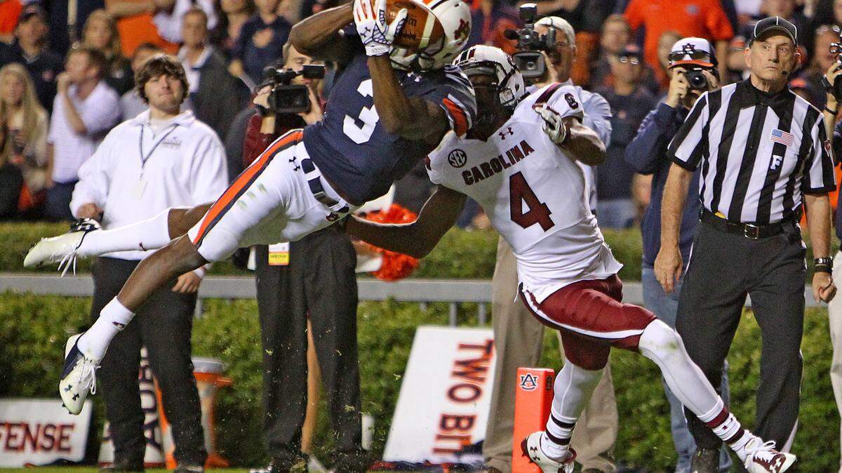 GERRY MELENDEZ/The State/Tribune News ServiceAuburn Tigers defensive back Jonathan Jones makes an acrobatic interception in front of South Carolina Gamecocks wide receiver Shaq Roland in the second half Oct. 25, 2014, at Jordan-Hare Stadium in Auburn, Ala. Auburn defeated South Carolina 42-35. Jones is looking forward to the challenges presented by the Bobby Petrino-led Louisville Cardinals.