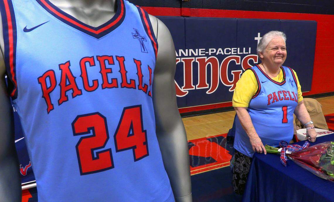 Sister Margaret Downing of the Sisters of Mercy greets well-wishers at St. Anne-Pacelli Catholic School on Dec. 9, 2024, after a ceremony honoring the Downing and Sister Pat Thompson, who are retiring. The school unveiled a special basketball jersey in their honor. 12/09/2024