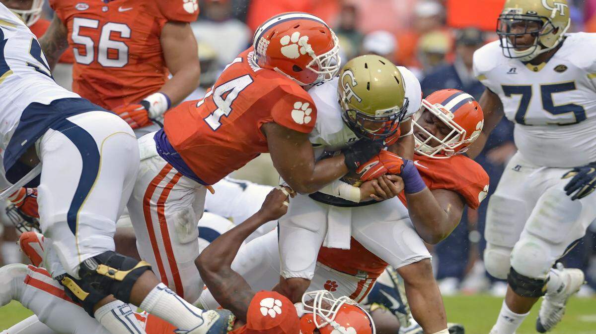 RICHARD SHIRO/Associated PressGeorgia Tech quarterback Justin Thomas is tackled by Clemson's B.J. Goodson, left, Carlos Watkins, right, and T.J. Burrell during the first half Saturday in Clemson, S.C.
