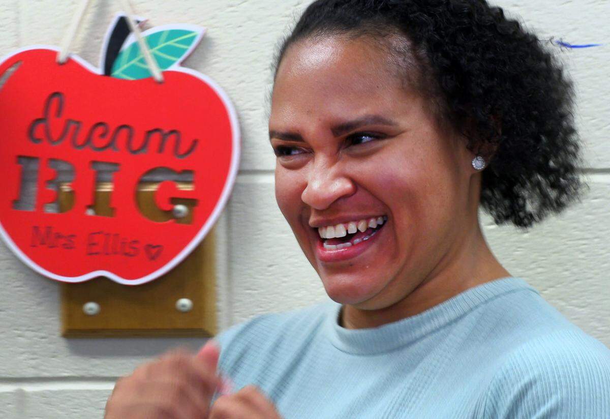 Vanessa Ellis, a teacher at Veterans Memorial Middle School, poses for a photo with her students after learning she is a Muscogee County School District 2022 Teacher of the Year finalist. 03/29/2022