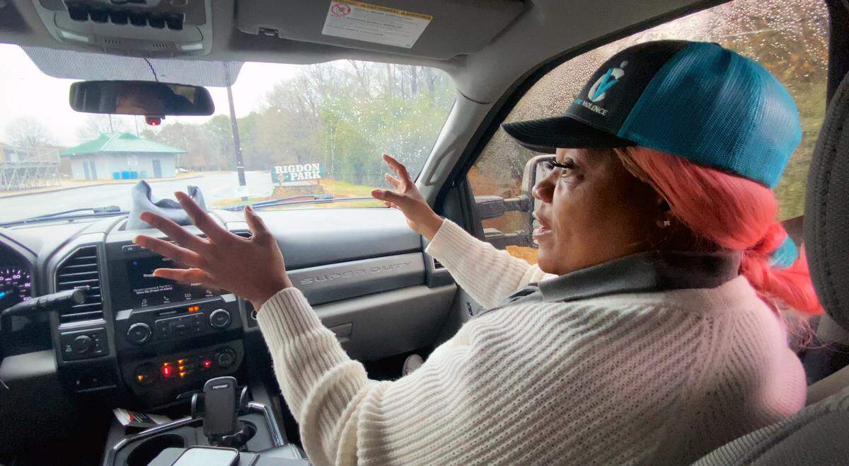 Kenyada McKenzie talks about the mission of Cure Violence Columbus while driving through Rigdon Park in Columbus, Georgia.