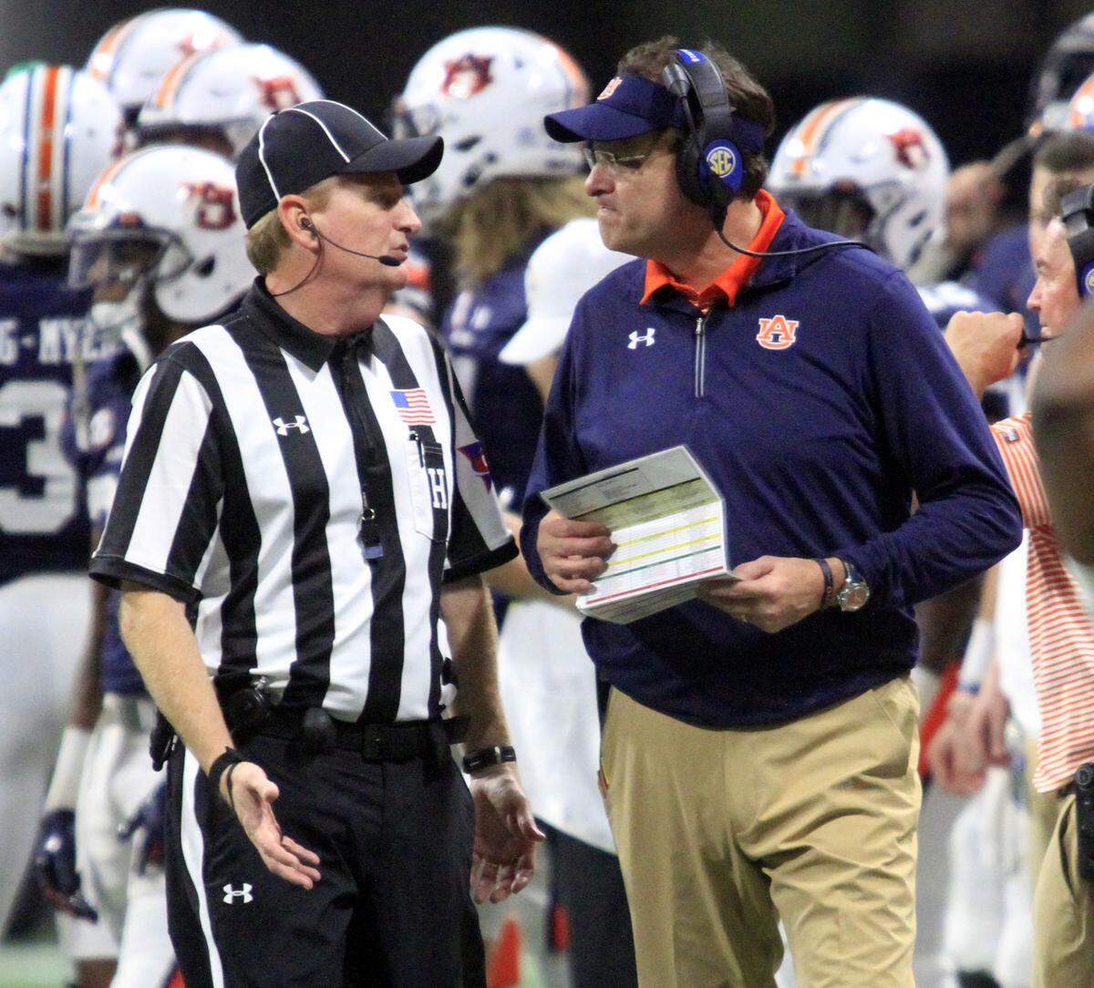 Auburn head coach Gus Malzahn talks with an official during the SEC Championship at Mercedes Benz Stadium in Atlanta Saturday. The Tigers lost to Georgia 28-7.