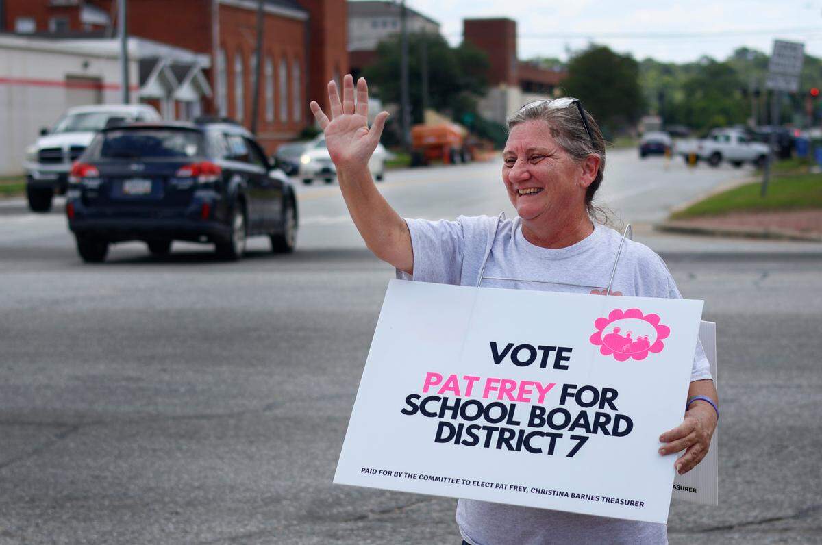 Pat Frey, a candidate for the District #7 seat on the Muscogee County School District board, campaigns Tuesday afternoon at the corner of Veterans Parkway and Ninth Street in Columbus, Georgia. 05/21/2024
