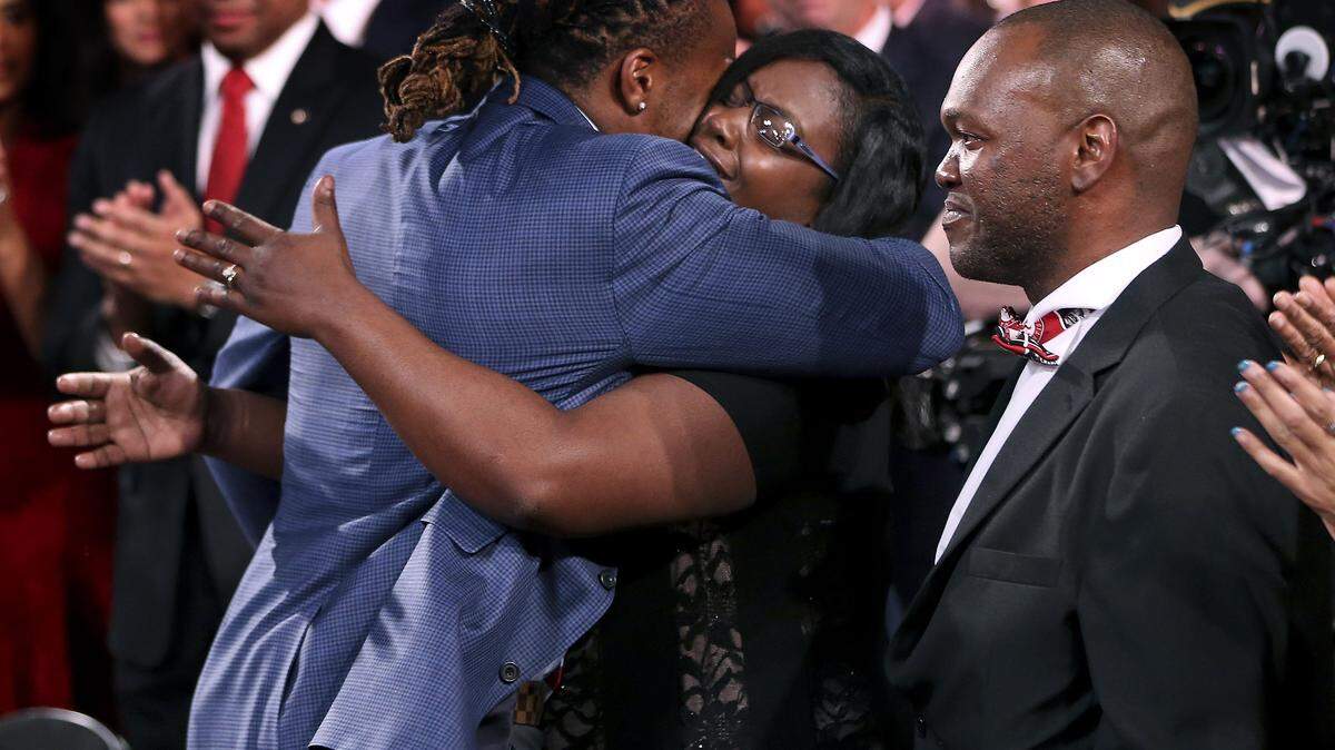 KELLY KLINE/Heisman Trust via APAlabama's Derrick Henry, left, hugs his mother, Stacy Veal after winning the Heisman Trophy, Saturday in New York.