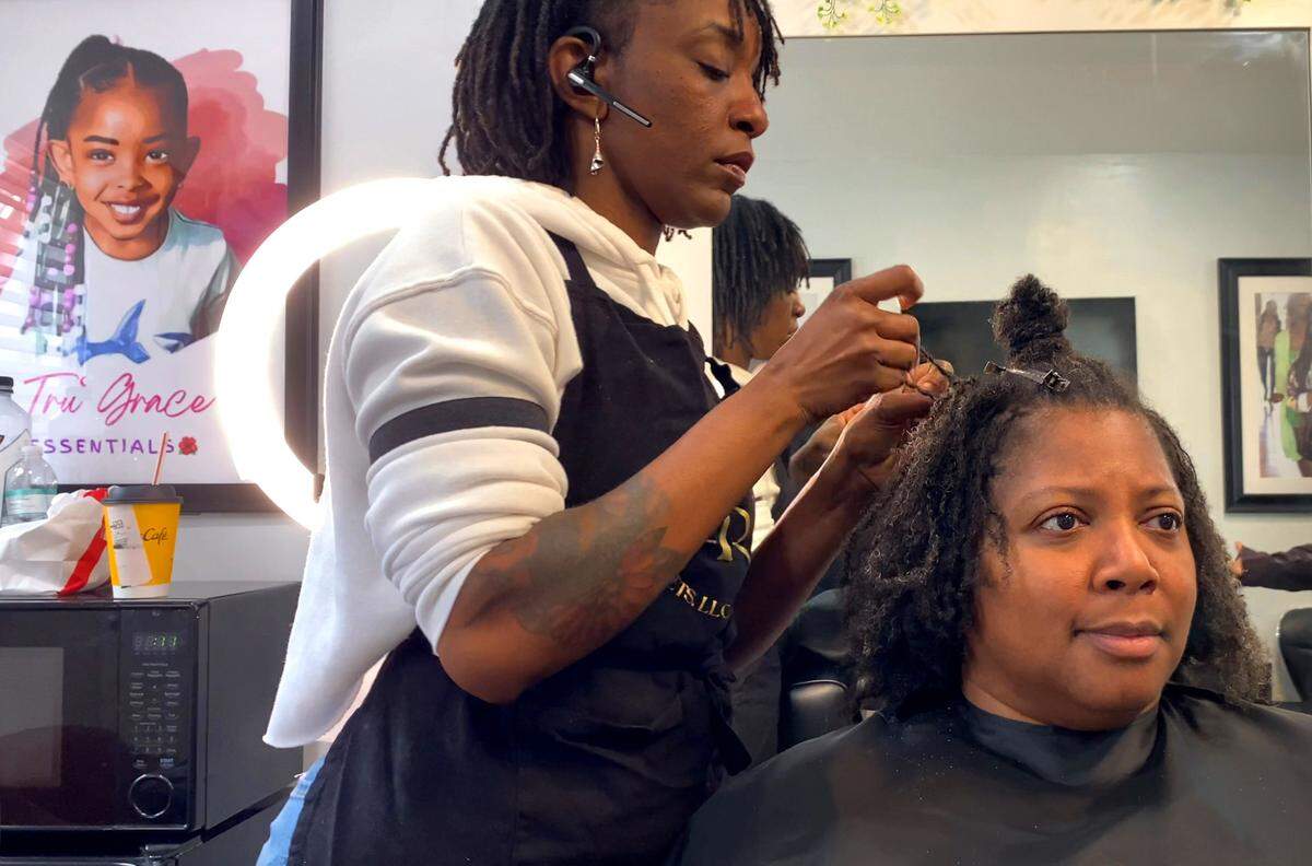 Taniesa Taylor, the owner of Locs, Twists, Braids and Crochets in Columbus, Georgia styles Shawnitra Williams’ hair recently. 01/11/2024