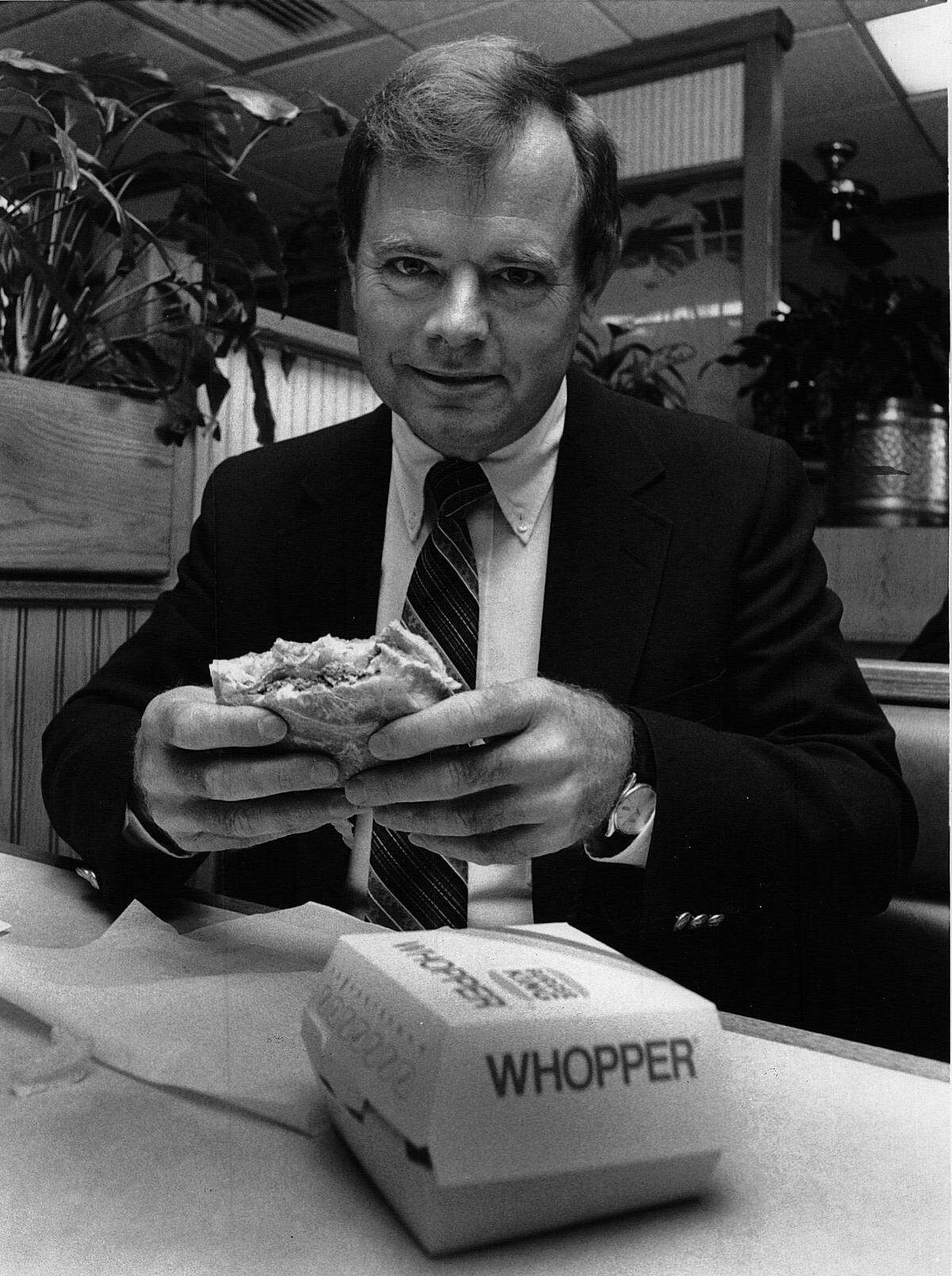 In this 1986 photo, Marvin Schuster is shown eating at one of his Burger King restaurants in Columbus.
