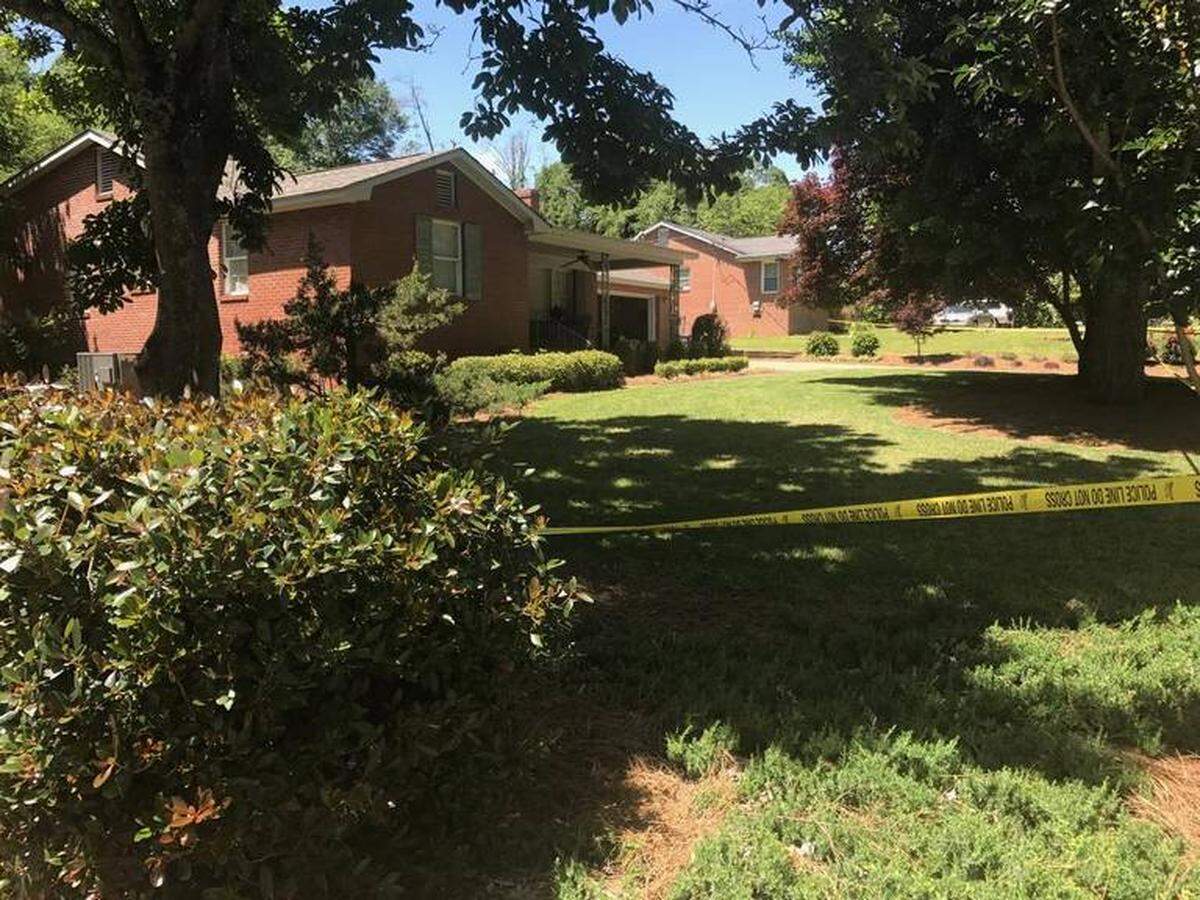 Crime-scene tape borders the yard April 29 at 1545 Alta Vista Drive, where 74-year-old William Meadows was found dead in the driver’s seat of his car, which was parked in his garage.