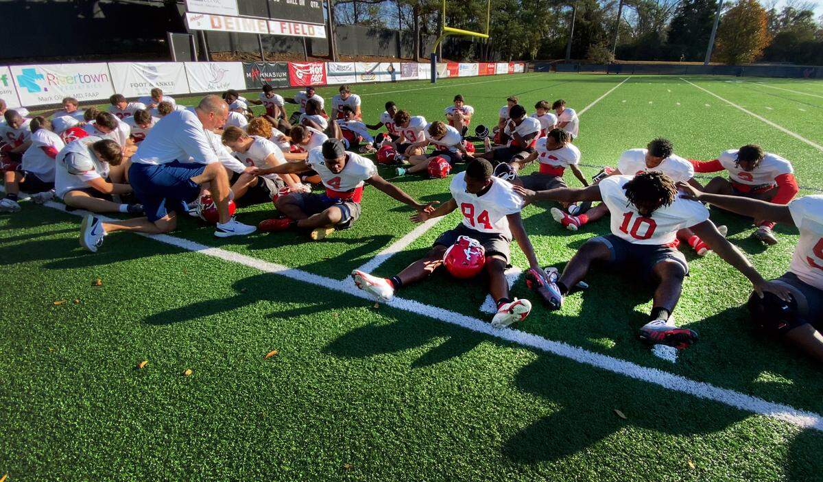 Dwight Jones, head football coach at St. Anne-Pacelli Catholic School in Columbus, Georgia, leads the team in prayer prior to the start of practice Wednesday, Dec. 1, 2022.