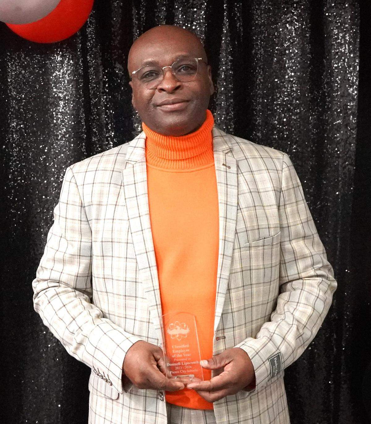 Donnell Lipscomb, a custodian at Sherwood, is the Phenix City Schools Classified Employee of the Year. He poses with his award at the PCS Night of Stars gala Dec. 7, 2023.
