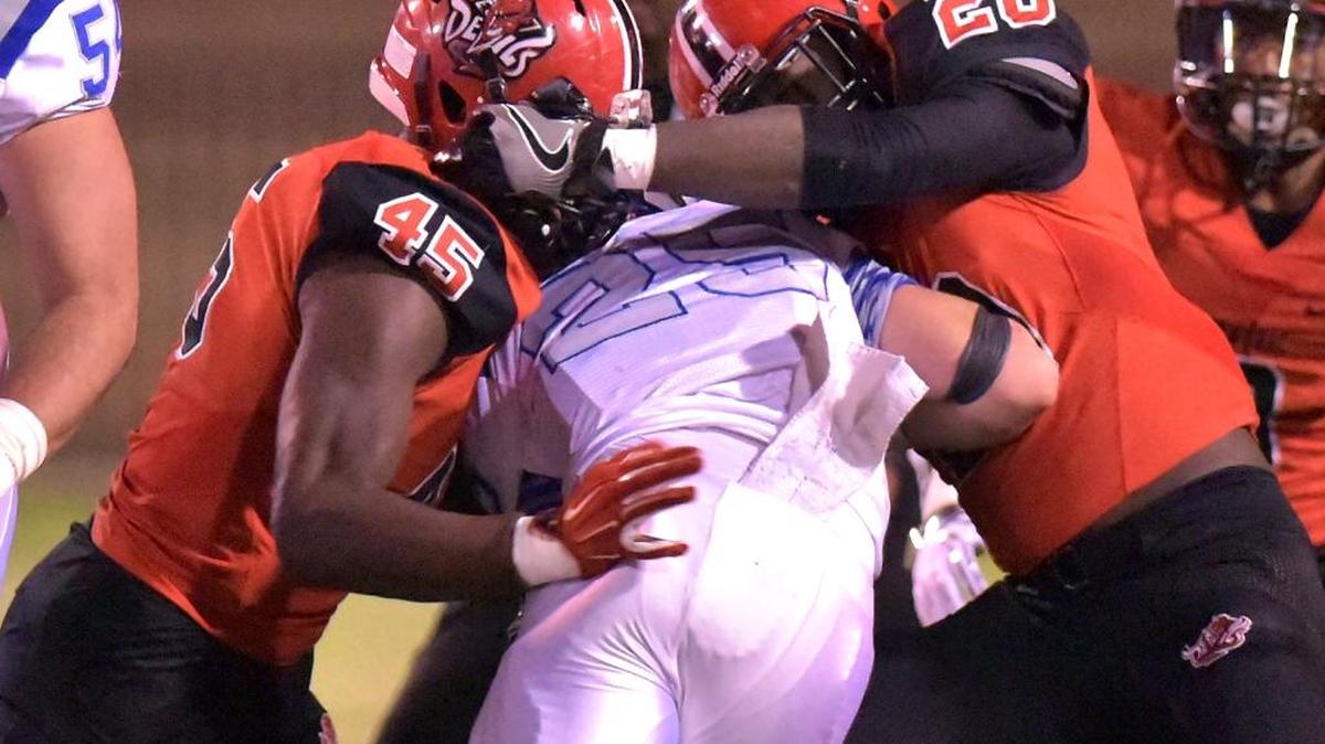 Central’s Dante Washington and Ravaughn Turner meet Auburn’s Garrett Morris behind the line of scrimmage and tackle him for a 1-yard loss in the first quarter Friday night.