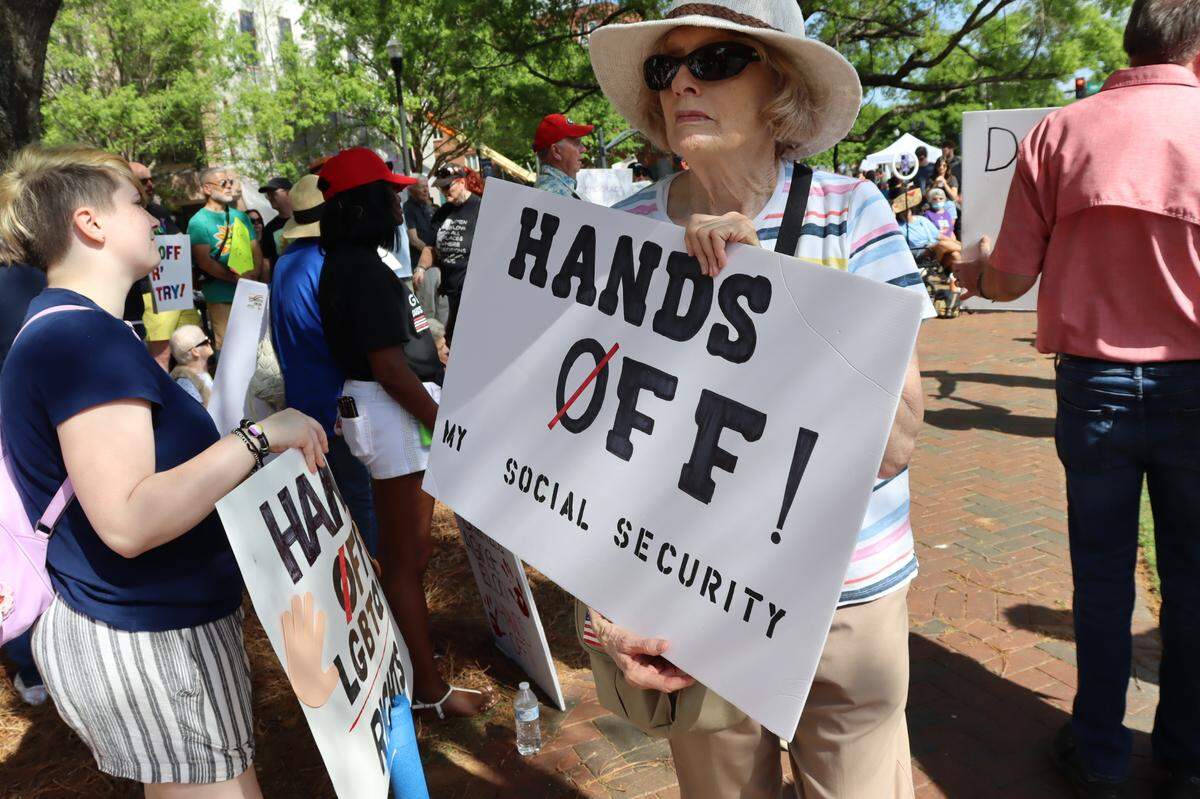 A protester holds a sign at the Hands Off protest in Columbus, 4/5/25 at 1000 Broadway Ave.