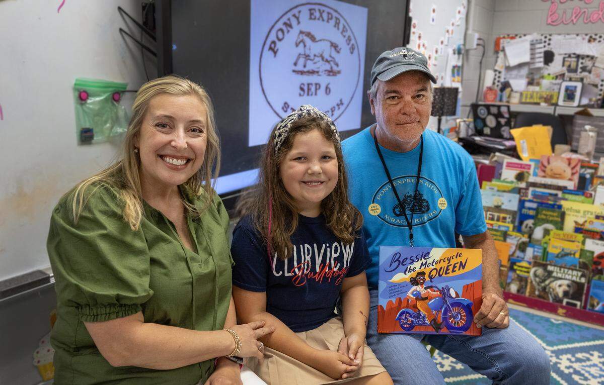 Miracle Rider Brian Brock, right, said he is planning to deliver a letter to the Pony Express Museum in St. Joseph, Missouri, written by students in teacher Lara Allan Lasseter’s second-grade class at Clubview Elementary School in Columbus.. His granddaughter Piper Evans, center, is in the class, where they are pictured April 29, 2026.
