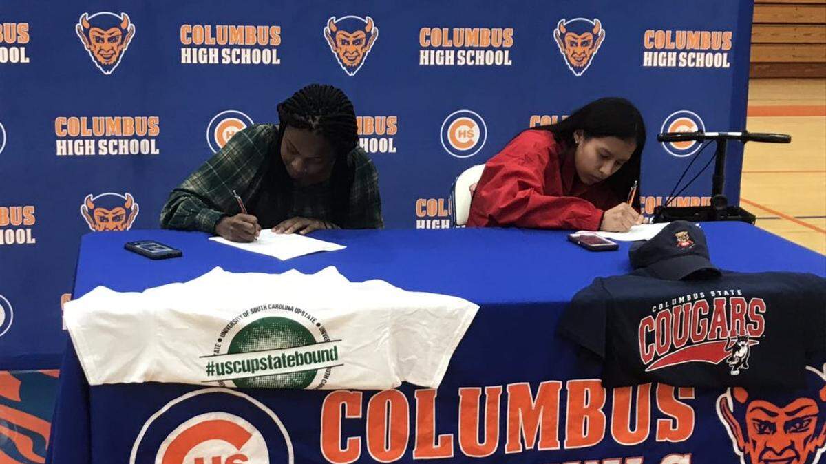 Columbus High athletes Heaven Allen (left) and Vanessa Aviles (right) sign collegiate letters of intent at a signing ceremony on Friday, Dec. 13, 2019 at the CHS Gymnasium. Four Blue Devil athletes signed letters of intent on Friday.