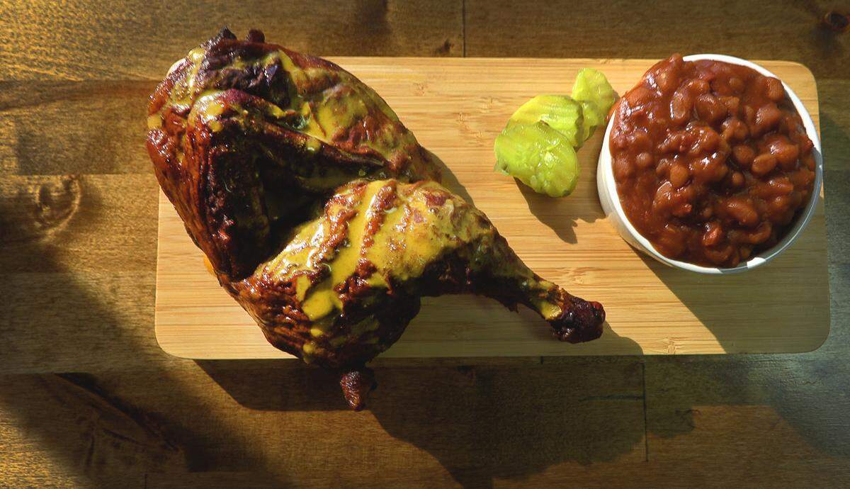 This is the half chicken and homemade baked beans at Mike & Ed’s Bar-B-Q location at 7590 Schomburg Road in Columbus, Georgia. 04/18/2023