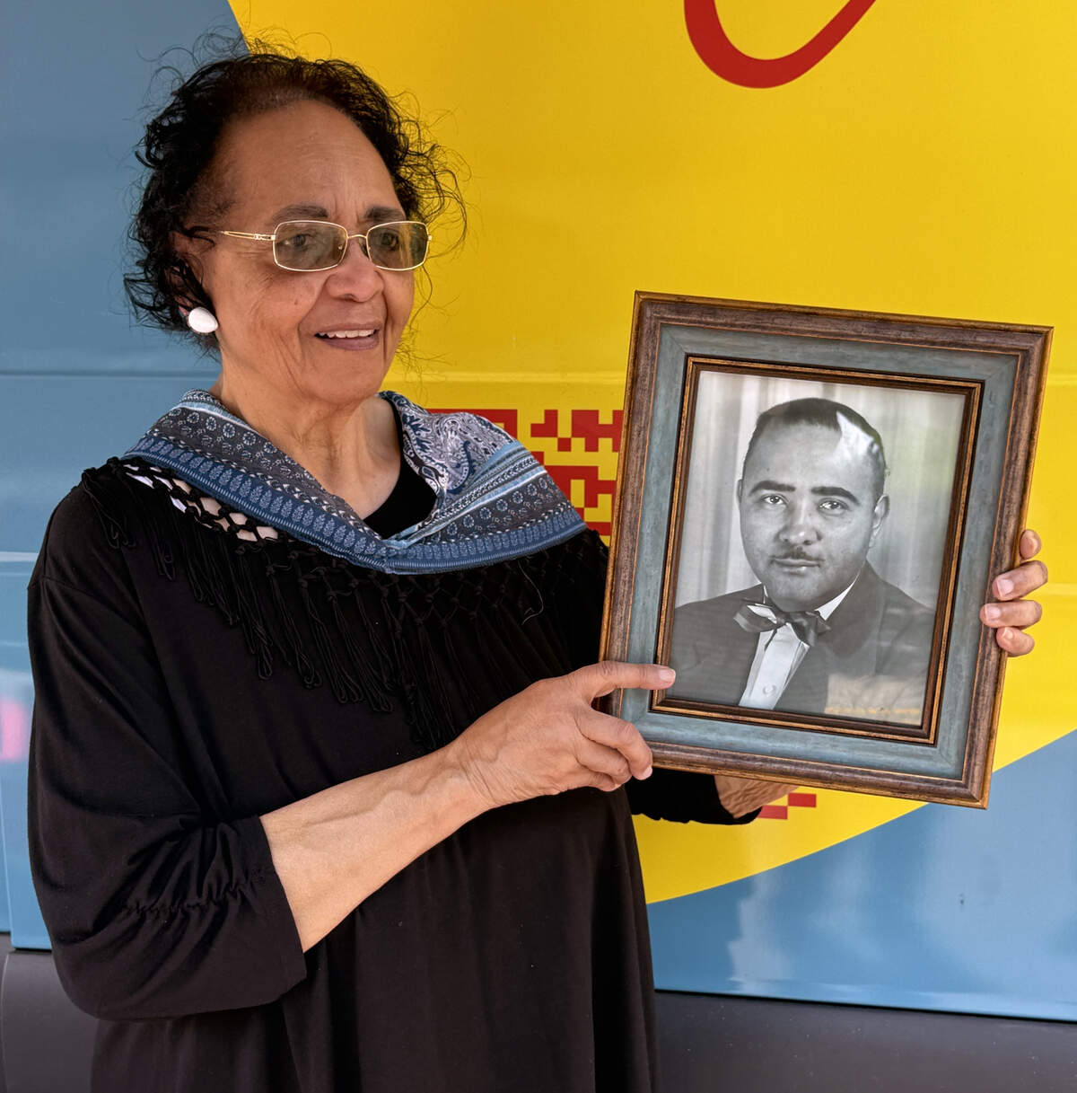 During the June 2026 StoryCorps visit to Columbus, Jettie Nesbitt Lights holds a photograph of her father, D.P. Nesbitt, who was a manager of the Liberty Theatre.