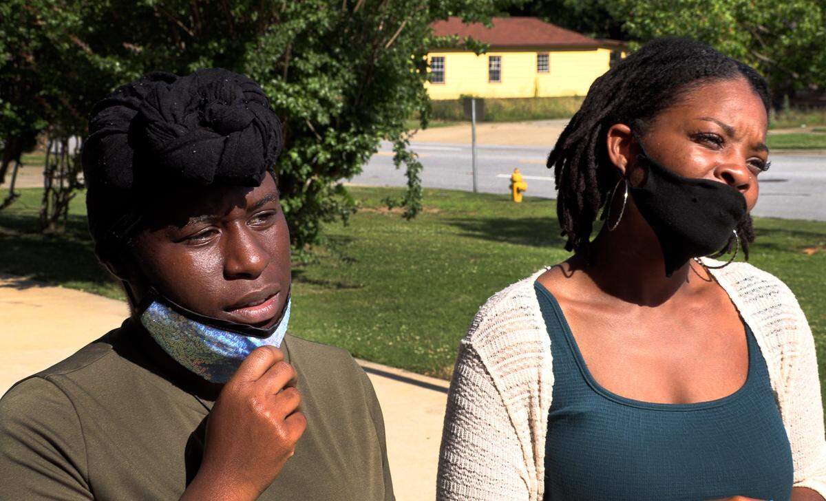 Jemima, left, and Eva Israel, the sisters of Charise Douglas, speak to reporters after a May 19 hearing in Columbus Recorder’s Court for Douglas, who is charged with murder in the fatal shooting of 38-year-old John Anthony Johnson.