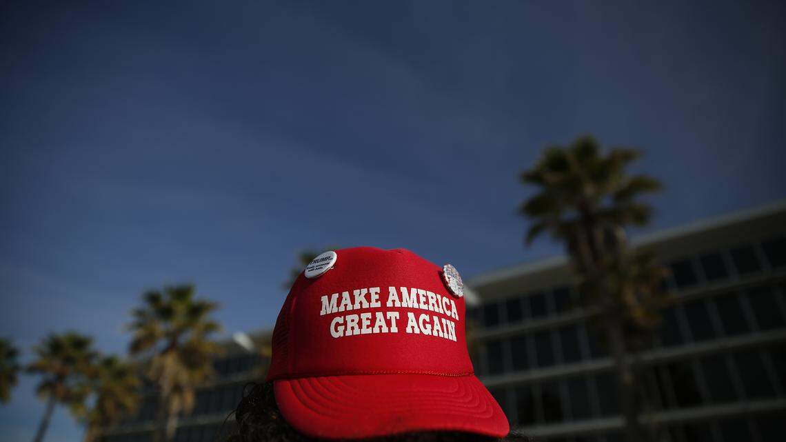 A supporter shows a Donald Trump hat before a campaign rally, Saturday, March 5, 2016, in Orlando, Fla. (AP Photo/Brynn Anderson)


