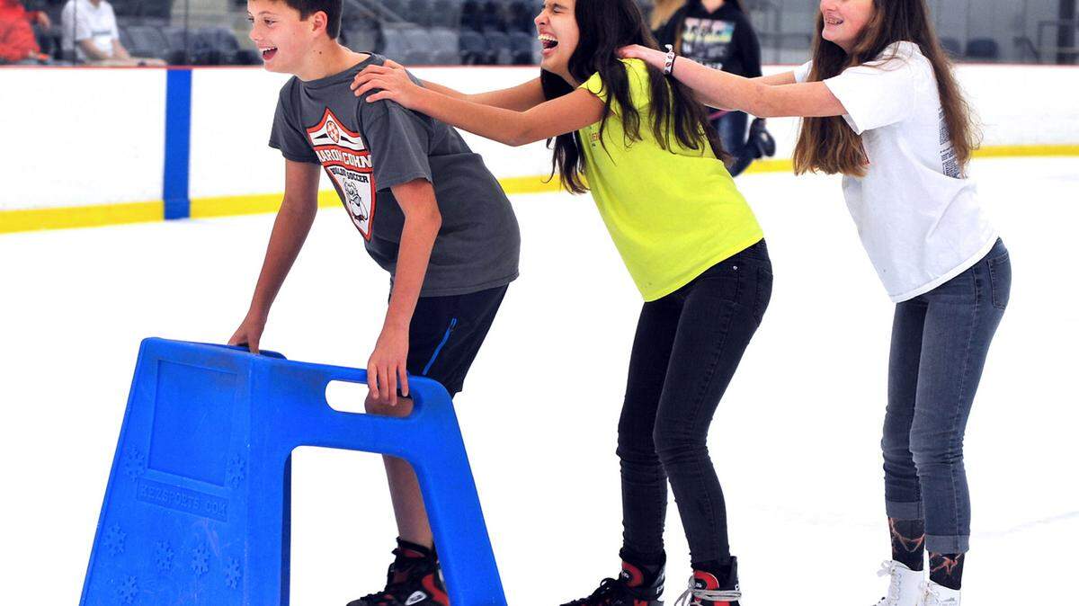Joshua Steinback, Amy Niece, and Jennifer Bright on the ice Saturday afternoon during the public skate session at the Columbus Ice Rink